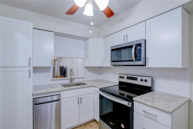 kitchen with sink, white cabinetry, and stainless steel appliances