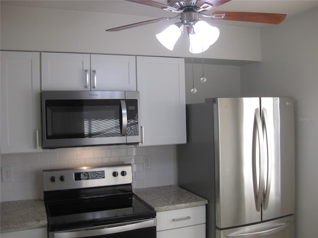 kitchen with ceiling fan, decorative backsplash, white cabinets, and appliances with stainless steel finishes