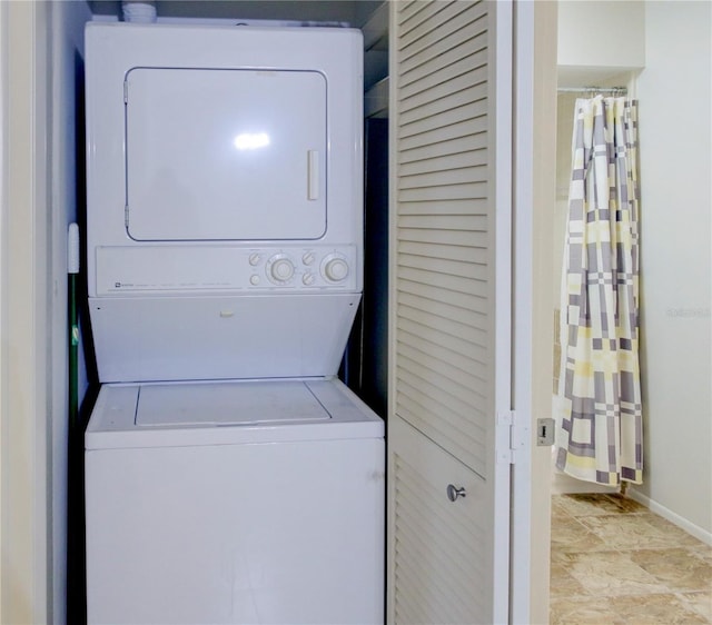 laundry area with stacked washer / dryer