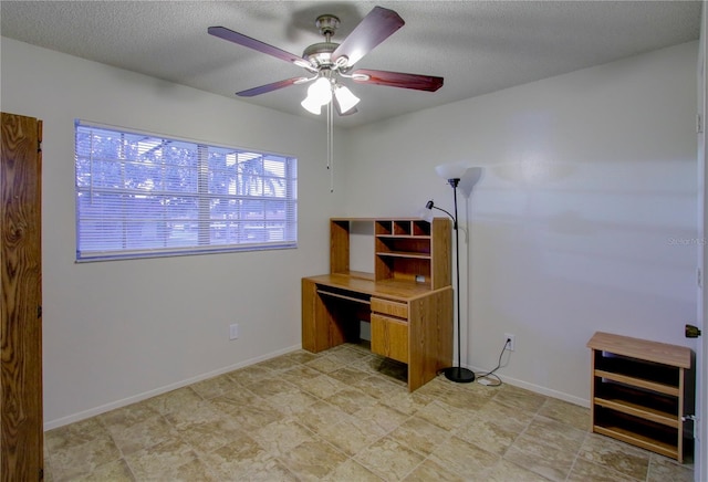 unfurnished office featuring ceiling fan and a textured ceiling