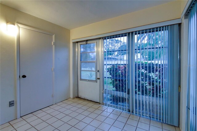 doorway with light tile patterned flooring