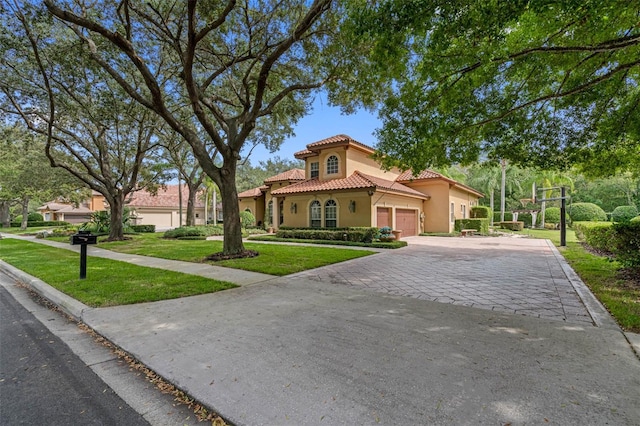 mediterranean / spanish home with a front yard