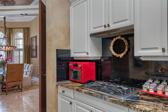 kitchen featuring white cabinetry, crown molding, decorative backsplash, and stainless steel gas stovetop