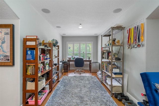 office area with a textured ceiling and wood-type flooring