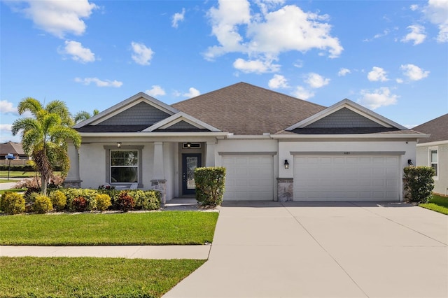 view of front of property featuring a front lawn and a garage