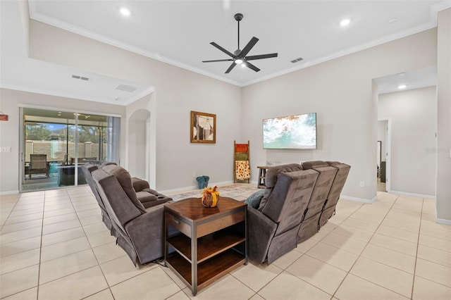 living room with ornamental molding, light tile patterned flooring, and ceiling fan