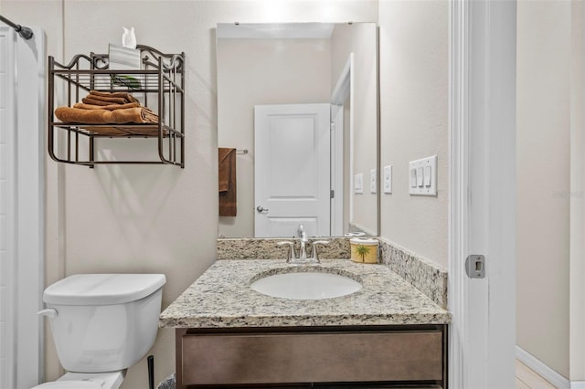 bathroom featuring vanity and toilet