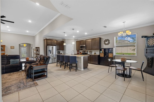 tiled living room featuring sink, crown molding, and ceiling fan with notable chandelier