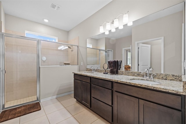 bathroom featuring vanity, walk in shower, and tile patterned floors