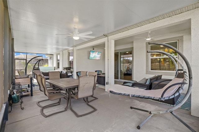 sunroom / solarium featuring ceiling fan