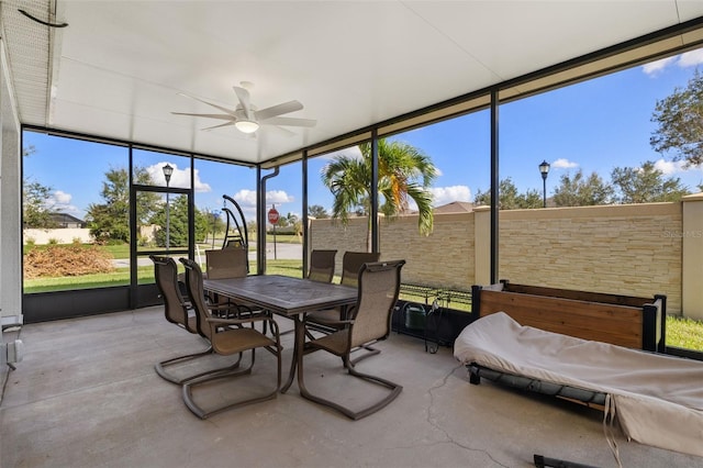 sunroom with ceiling fan and plenty of natural light