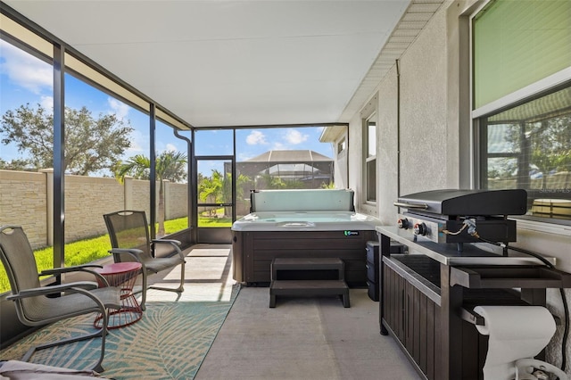 sunroom / solarium featuring a hot tub and plenty of natural light