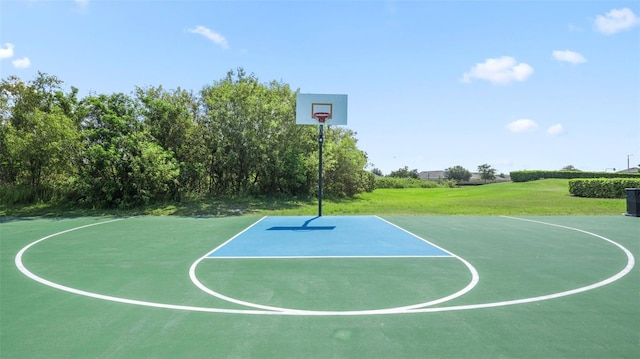 view of sport court featuring a lawn