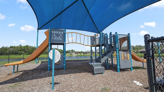 view of jungle gym featuring a water view