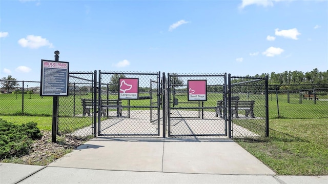 view of gate featuring a yard