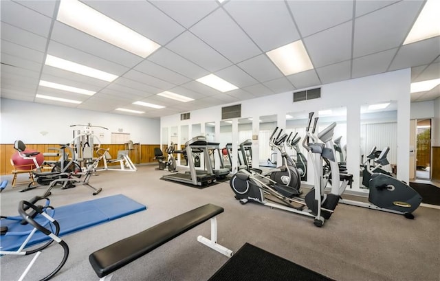 7625 Sun Island Dr S Unit 101, South Pasadena, FL 33707 - exercise room featuring a drop ceiling, wainscoting, and wooden walls