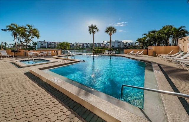 view of pool featuring a hot tub and a patio area