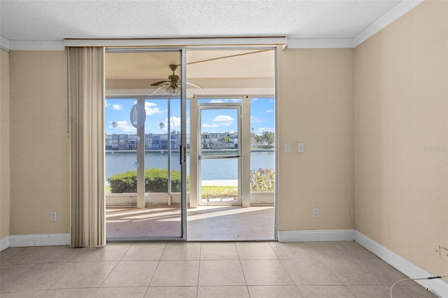 7625 Sun Island Dr S Unit 101, South Pasadena, FL 33707 - spare room featuring a water view, ornamental molding, a textured ceiling, ceiling fan, and tile patterned floors