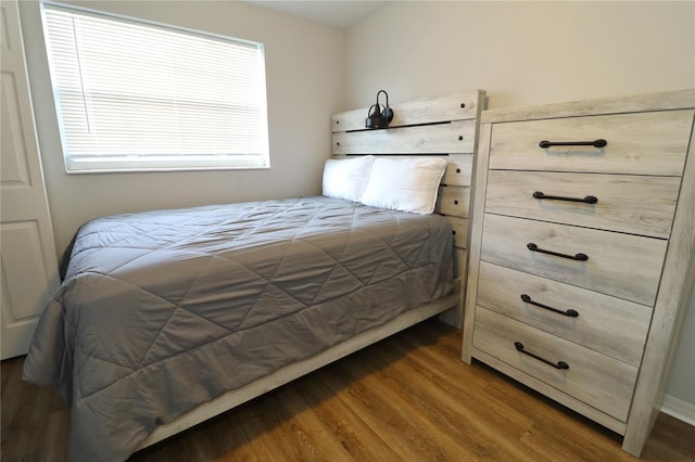 bedroom with dark wood-type flooring