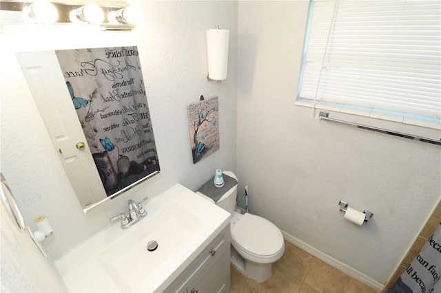 bathroom with vanity, tile patterned flooring, and toilet