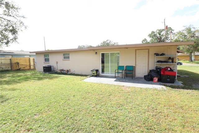 back of house featuring central AC and a yard