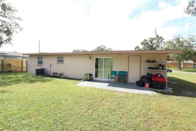 back of property featuring a lawn, central AC, and a patio area