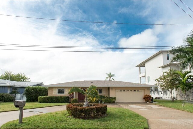 view of front of home featuring a front yard and a garage