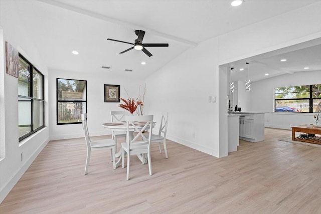 unfurnished dining area featuring vaulted ceiling with beams, ceiling fan, and light hardwood / wood-style floors