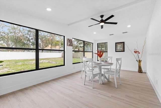 dining area featuring ceiling fan, lofted ceiling, and light hardwood / wood-style flooring