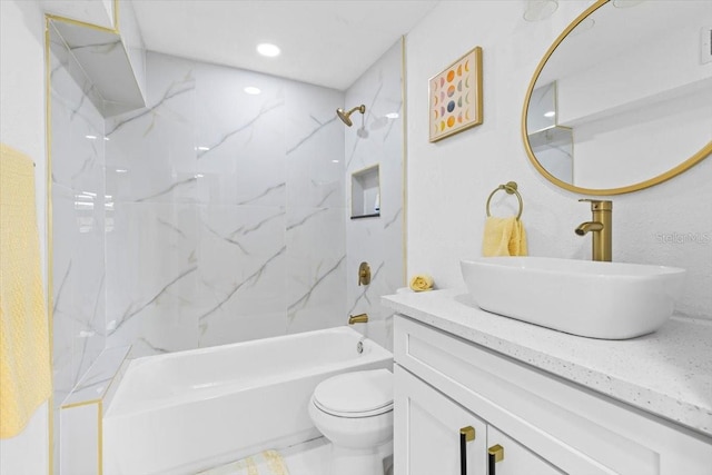 full bathroom featuring vanity, toilet, and tiled shower / bath