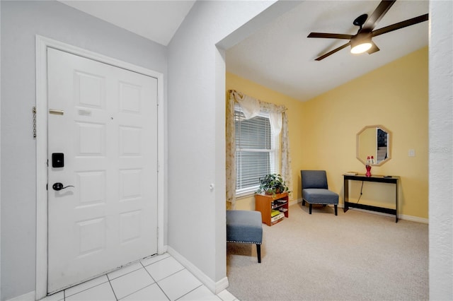 foyer entrance with ceiling fan, lofted ceiling, and light colored carpet