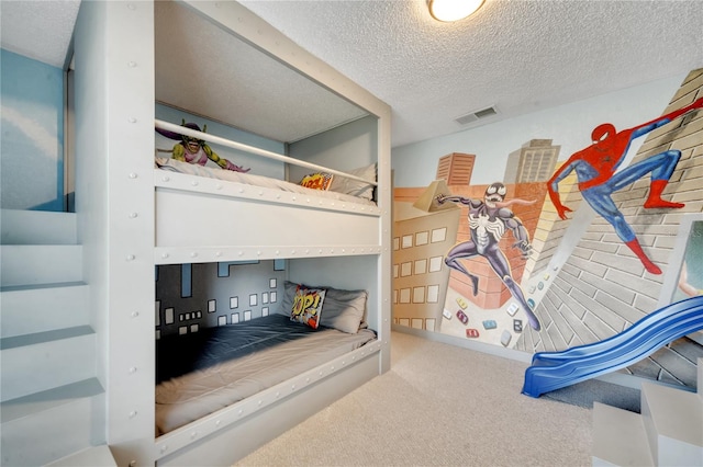 bedroom with a textured ceiling and carpet flooring