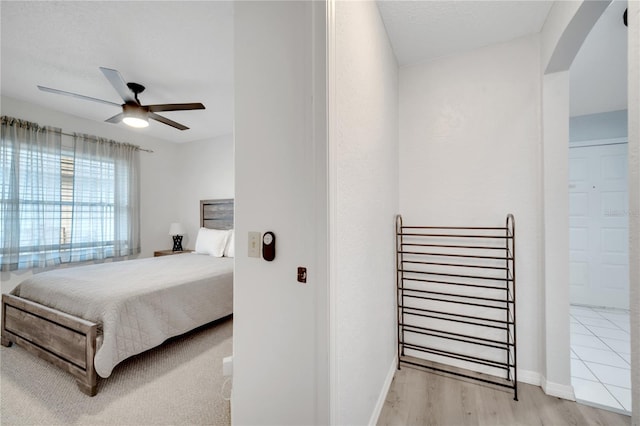 bedroom with light hardwood / wood-style floors and ceiling fan