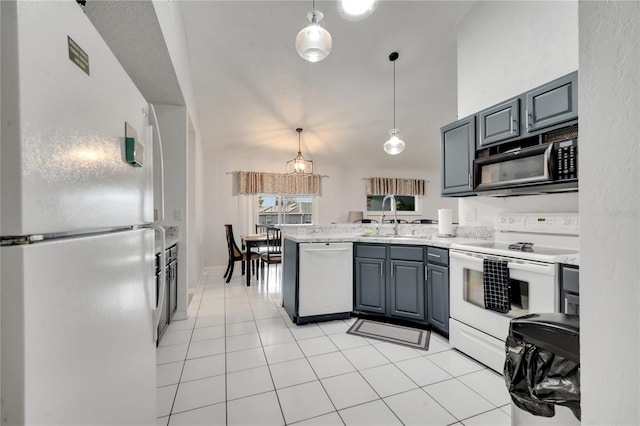 kitchen with gray cabinetry, sink, decorative light fixtures, light tile patterned floors, and white appliances