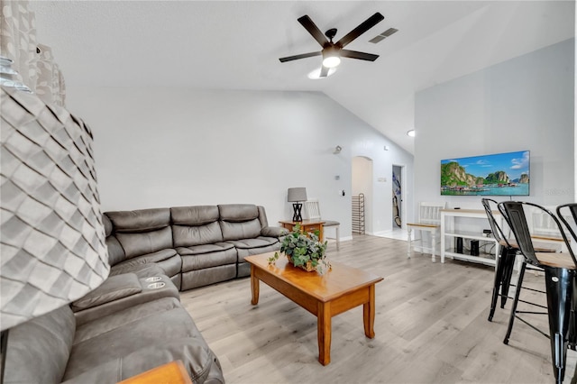 living room with light hardwood / wood-style flooring, high vaulted ceiling, and ceiling fan