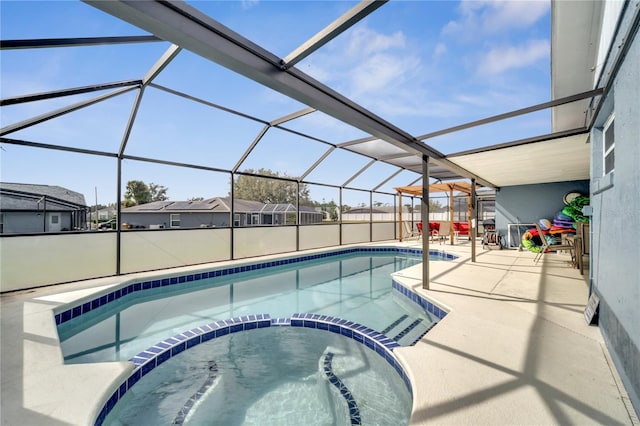 view of pool featuring a patio, an in ground hot tub, and glass enclosure