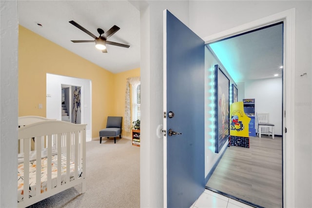 corridor with lofted ceiling and light hardwood / wood-style flooring