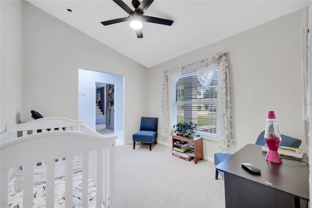 bedroom featuring carpet, vaulted ceiling, a crib, and ceiling fan