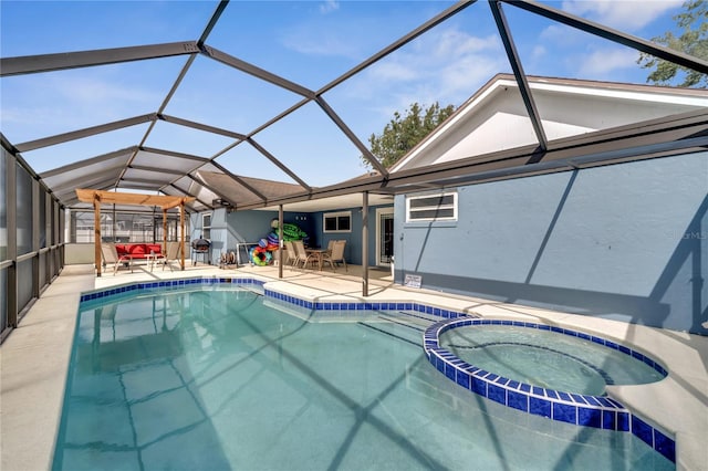 view of swimming pool with a patio, an in ground hot tub, and a lanai