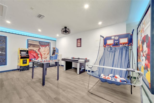 game room with light hardwood / wood-style flooring