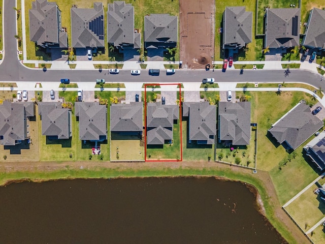 birds eye view of property featuring a water view