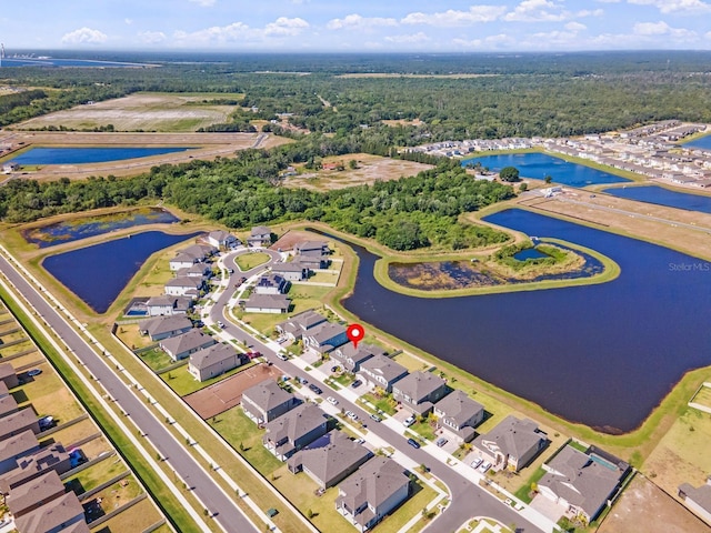 birds eye view of property with a water view