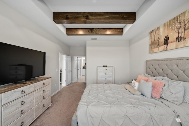 bedroom featuring light carpet and a tray ceiling