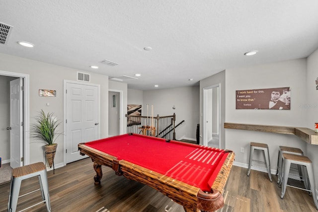 recreation room featuring a textured ceiling, dark hardwood / wood-style flooring, and billiards