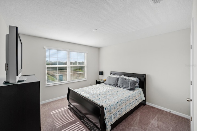 bedroom with carpet and a textured ceiling