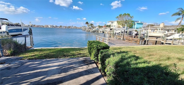 view of dock featuring a yard and a water view