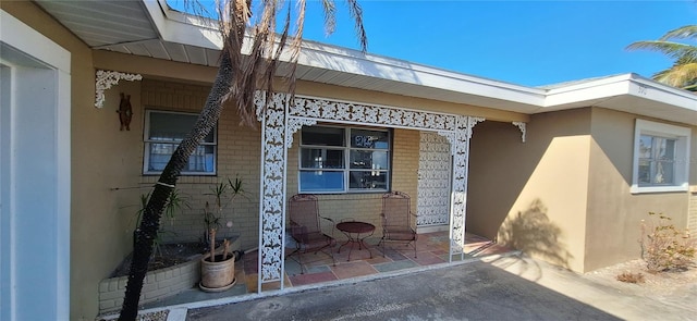 doorway to property with a patio