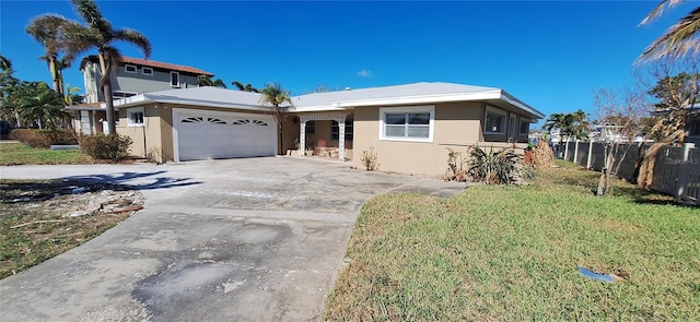 view of front of property featuring a front yard and a garage