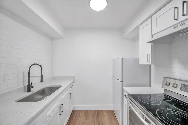 kitchen featuring light wood-type flooring, sink, white cabinetry, and electric stove