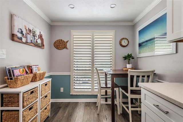 dining room with dark wood-type flooring and ornamental molding